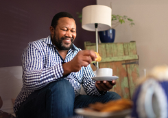 man with tea and biscuits