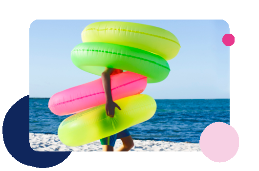 Person carrying inflatable rings on a beach